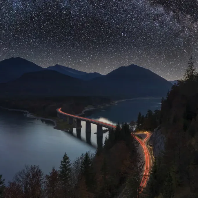 Milky Way over Alpine Road in Alps Milky Way at Lake sylvester - Sylvensteinspeicher